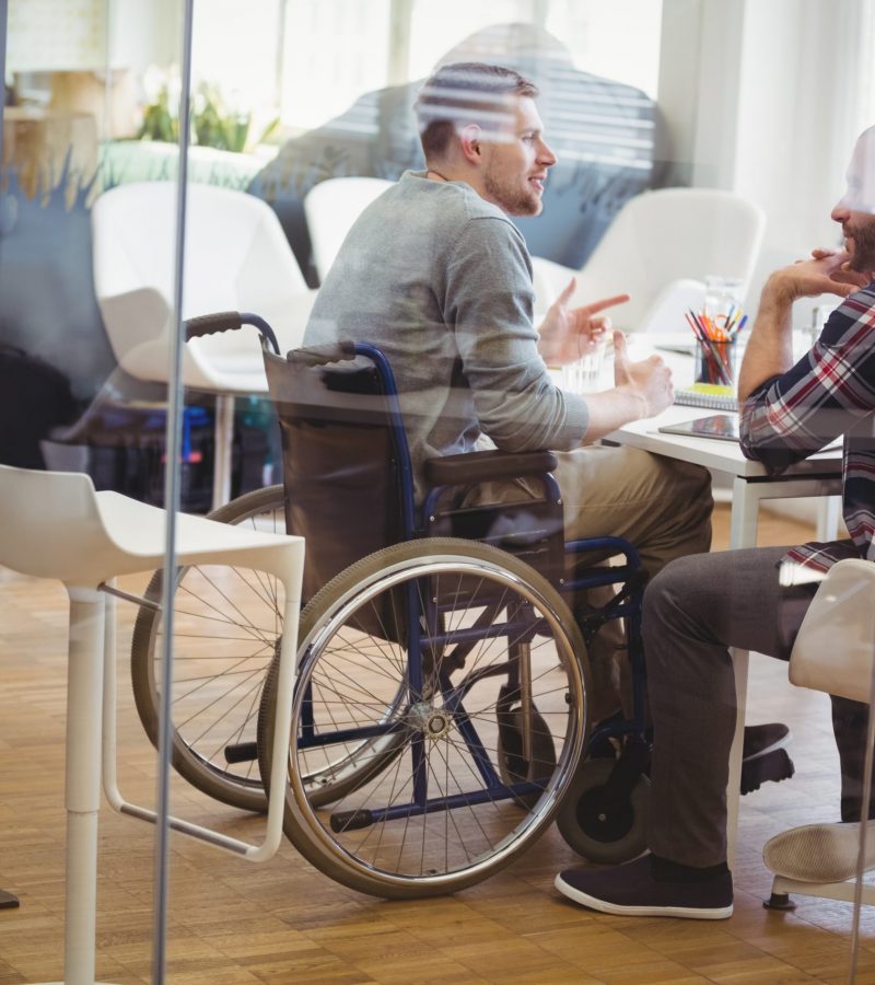 Full length of handicap businessman discussing with colleague 770226